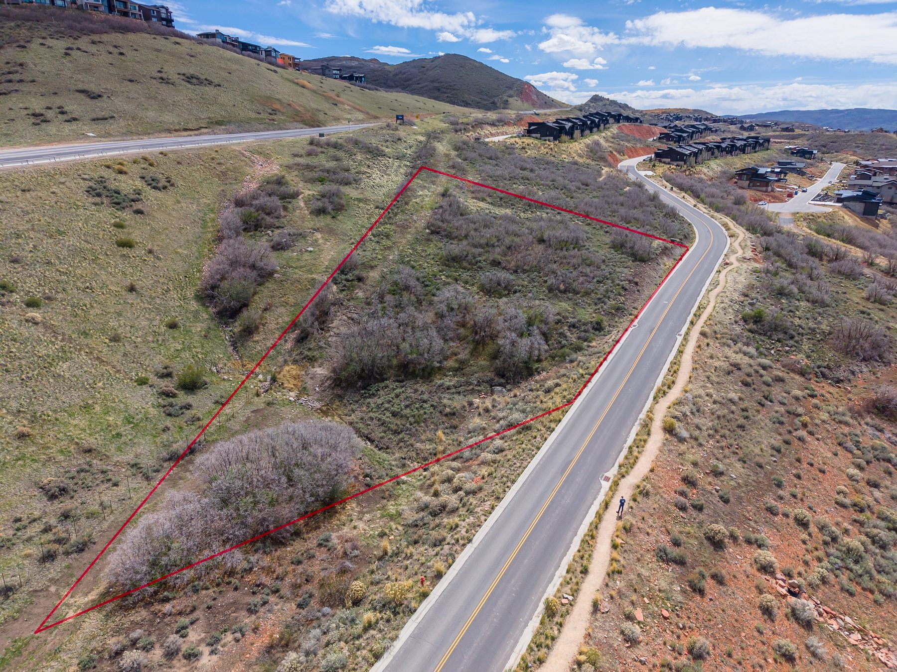 Aerial drone photo with red lot boundary lines showing the 1.13-acre parcel at 11422 N Shoreline Drive, Hideout Utah